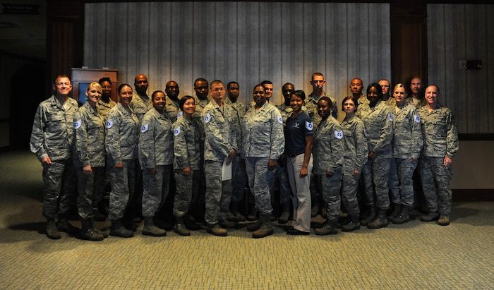 Col. Richard McComb (left), 628th Air Base Wing commander and Chief Master Sgt. Al Hannon (right), 628th Air Base Wing command chief, welcome the 628th ABW's new technical sergeants at a release party at Joint Base Charleston- Air Base June 21. (U.S. Air Force photo/Airman 1st Class Ashlee Galloway)