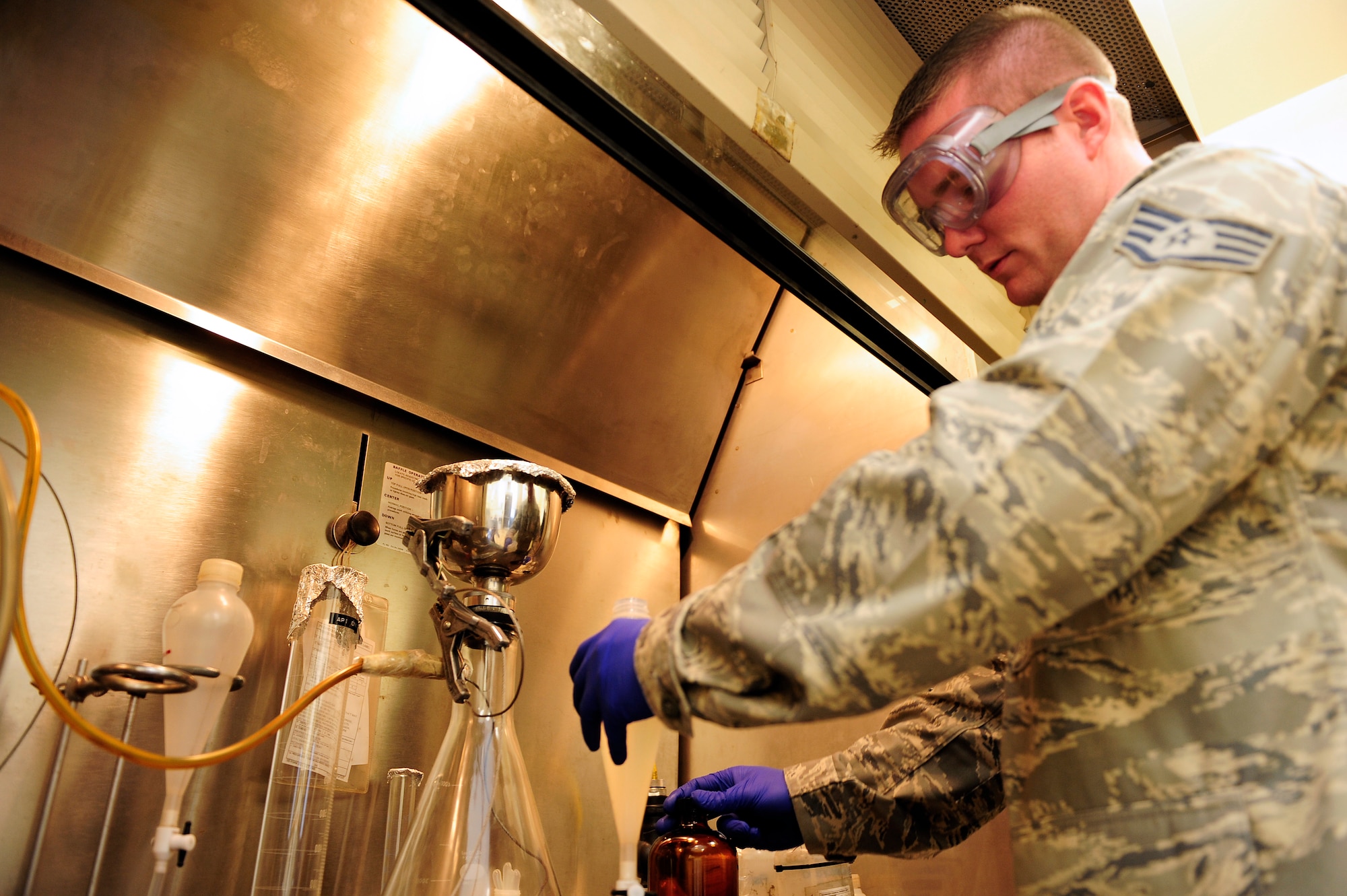 Staff Sgt. Jesse Ball, 20th Logistics Readiness Squadron fuels lab technician, observes a fuel sample, checking the fuel’s levels and additives at Shaw Air Force Base, S.C., June 26, 2012. Quality assurance is necessary to verify that any fuel that goes into aircraft will yield maximum results and performance. (U.S. Air Force photo by Airman 1st Class Daniel Blackwell/Released)