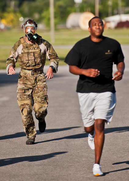 Chief Master Sgt. Al Schneider, of the 366th Training Squadron Det. 3, completes the 5K run in a MCU-2P gas mask at Eglin Air Force Base, Fla., June 26.  More than 50 runners turned out for the run to honor and remember Tech. Sgt. Daniel Douville, an explosive ordnance disposal Airman from Eglin, who was killed in Afghanistan.  The run, which was led by the 96th EOD flight, marked the one year anniversary of his death.  Douville’s name was added to the EOD Memorial Wall earlier this year.  (U.S. Air Force photo/Samuel King Jr.)