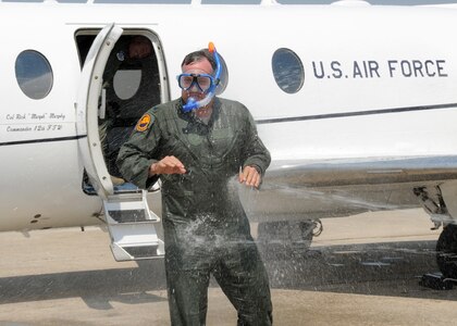 Col. Richard Murphy, 12th Flying Training Wing commander, gets drenched after completing his final flight as commander in a T-1 Jayhawk aircraft on Joint Base San Antonio-Randolph, Texas, June 25. (U.S. Air Force photo by Melissa Peterson)