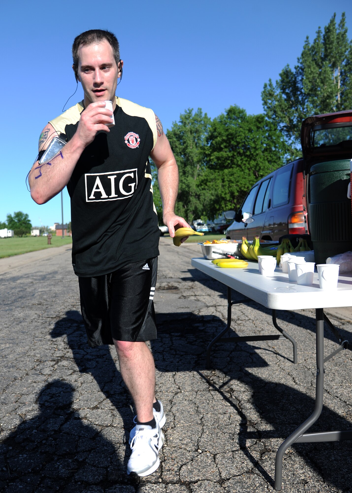 Tech. Sgt. Tony Vaughan, 319th Civil Engineer Squadron, hydrates during the half marathon, June 21, 2012, on Grand Forks Air Force Base, N.D. (U.S. Air Force photo/Airman 1st Class Ashley N. Taylor)