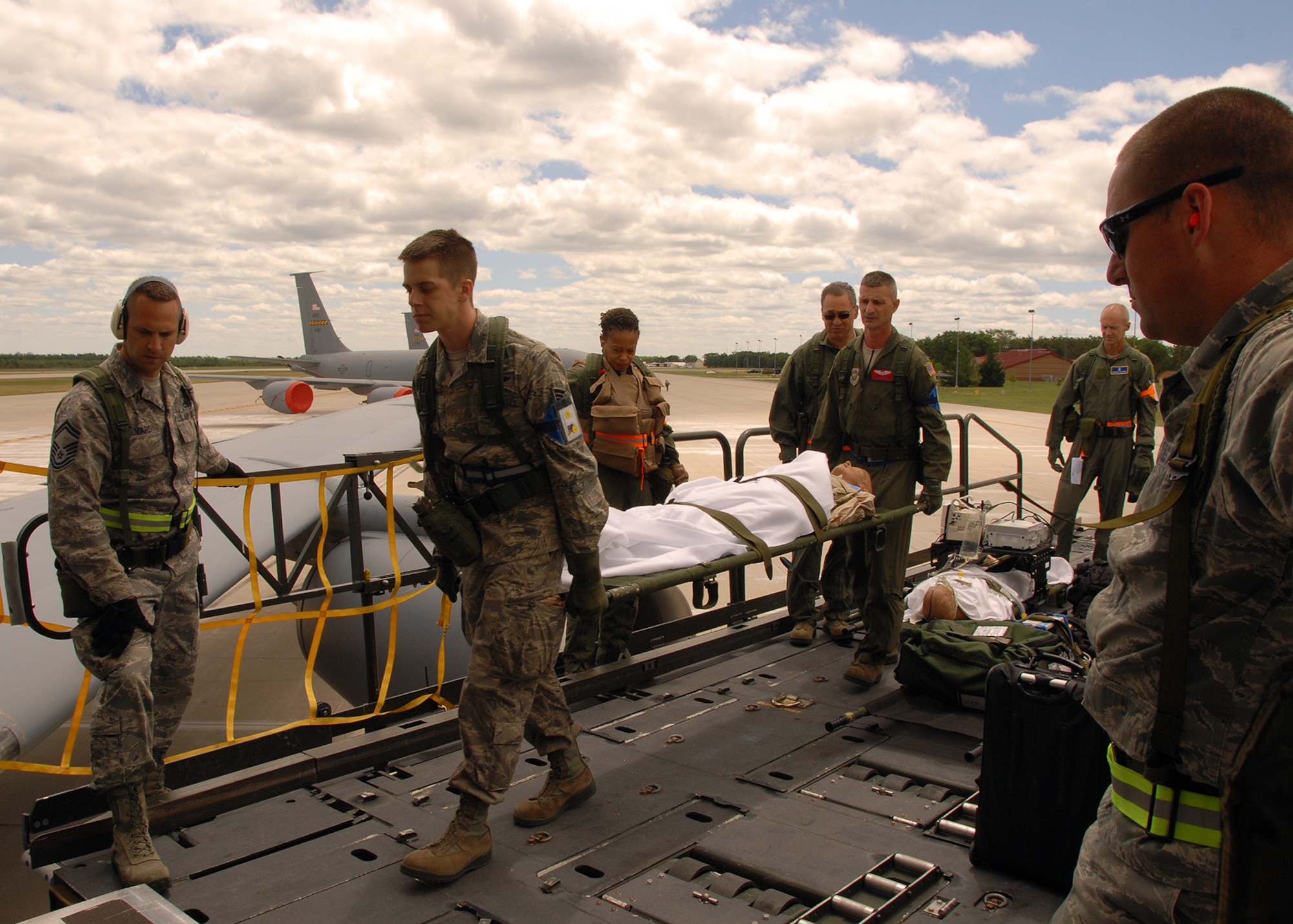 Members from the 137th, 459th and 507th Air Refueling Wings work to load patients and equipment for transport in participation of Exercise Crisis Reach 12-04A June 12, 2012 at the 124th Air Expeditionary Wing in Alpena, Mich.  The 137th, 459th and 507th Air Refueling Wings joined forces for an Operational Readiness Inspection.  (USAF Photo by Tech. Sgt. Roberta A. Thompson)
