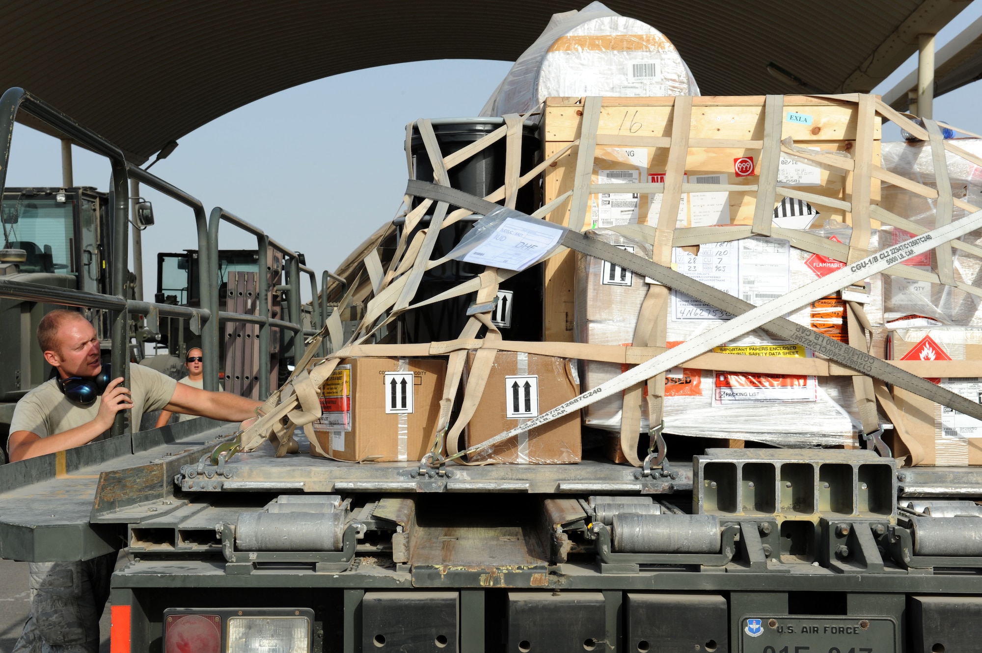 SOUTHWEST ASIA - Senior Airman Zachary Burson, 380th Expeditionary Logistics Readiness Squadron Air Terminal Operations Center technician, unfastens a cargo strap in their cargo yard June 25, 2012. All the mission's parts, supplies and passengers coming to the 380th Air Expeditionary Wing come through the ATOC. (U.S. Air Force photo/Master Sgt. Scott MacKay)