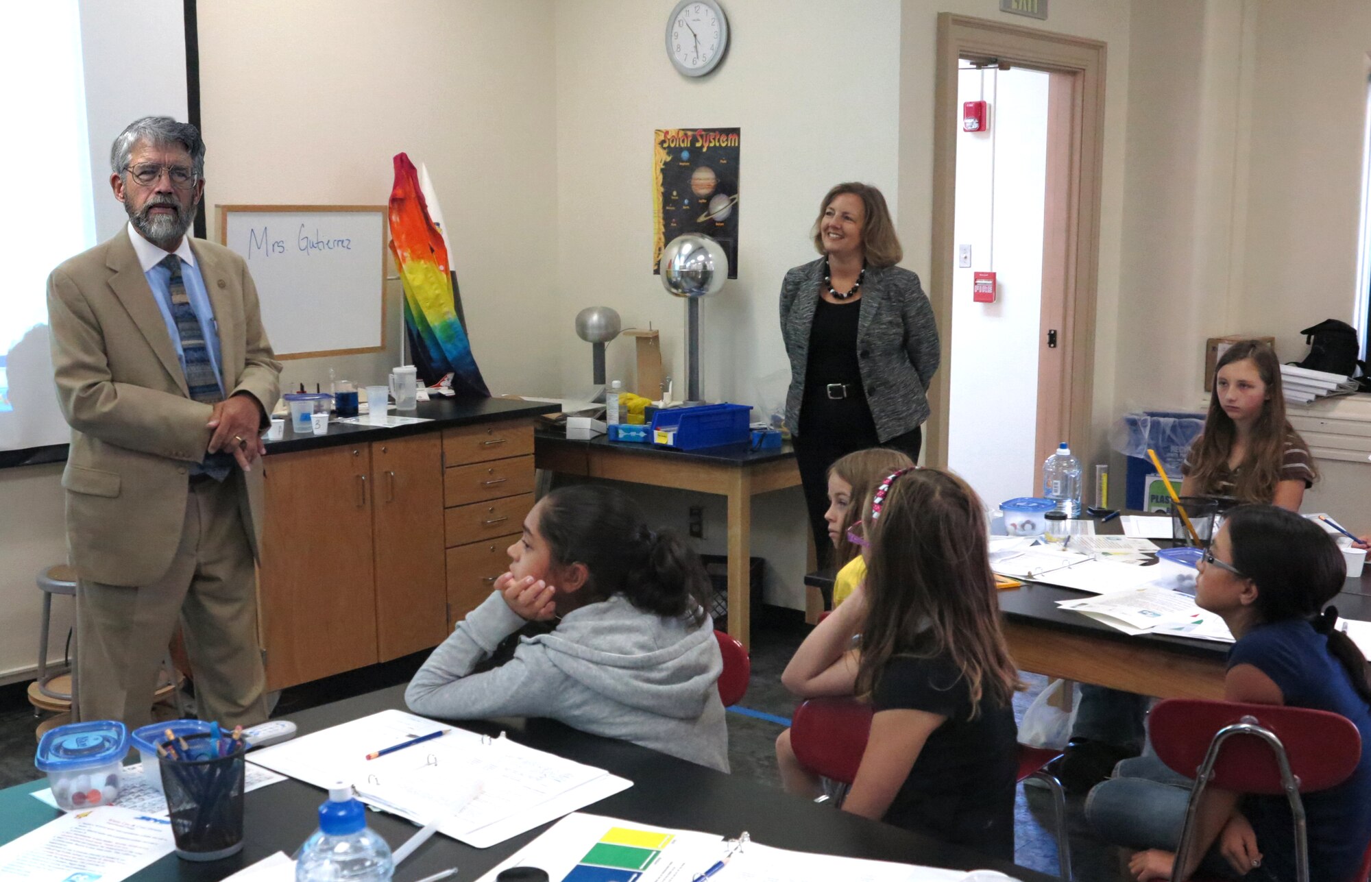 KIRTLAND AFB, N.M. -- Dr. John P. Holdren, director, White House Office of Science and Technology Policy and assistant to the president for science and technology, visited the Air Force Research Laboratory's La Luz Academy at Kirtland Air Force Base on June 7. La Luz Academy is an education outreach program for students in grades 5-12, with the goal of increasing their interest in pursuing science, technology, engineering and math-related studies and career paths. The program focuses on applications of the basic STEM concepts behind the technologies AFRL's Directed Energy and Space Vehicles Directorates develop. AFRL La Luz Academy Director Ronda Cole observes while Dr. Holdren speaks to students. (Courtesy photo) 