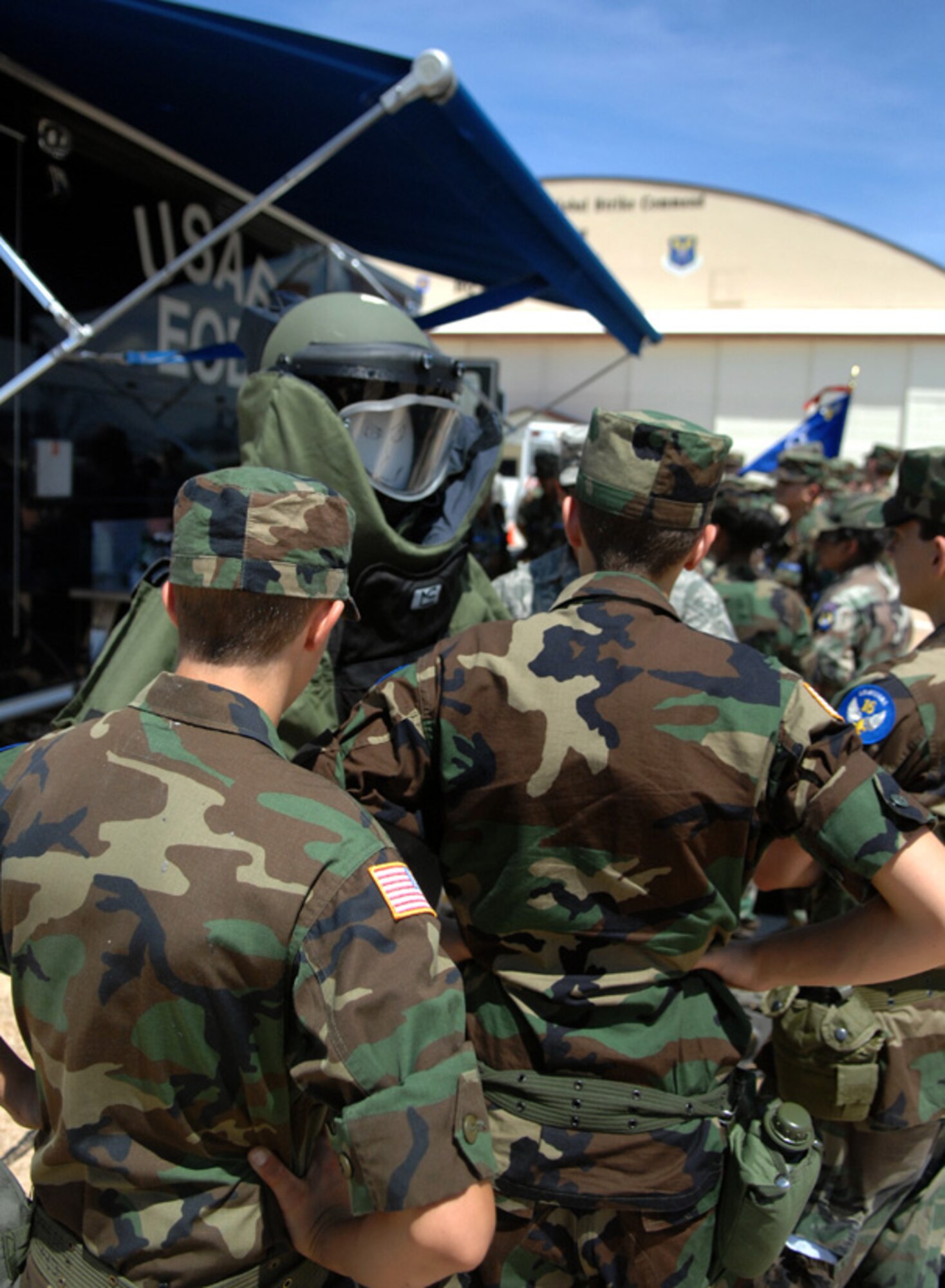 Civil Air Patrol cadets listen and ask questions at a 2nd Civil Engineer Squadron explosive ordnance disposal flight display during Barksdale Air Force Base Career day at Hoban Hall, June 20. The EOD disarms live explosives, bombs, un-exploded ordnance, and more for the Air Force and local community. (U.S. Air Force photo/Staff Sgt. Jason McCasland)(RELEASED)