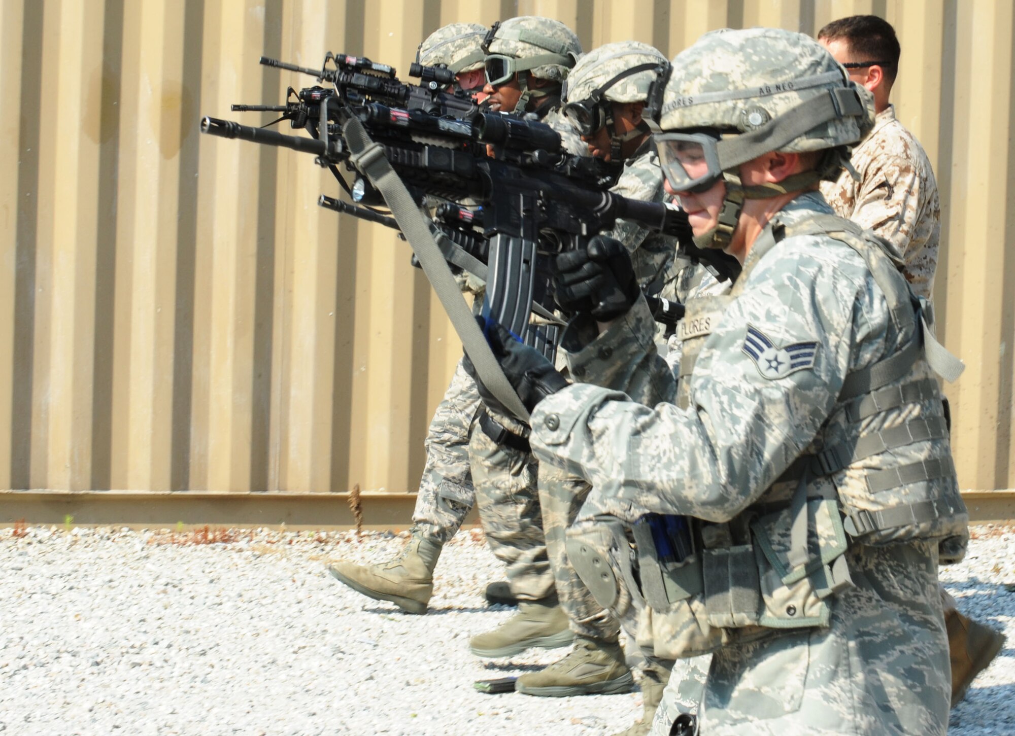 Members of the 633rd Security Forces Squadron move forward in a line while firing at stationary targets at Fort Eustis, Va., June 21, 2012. During this training, participants had to fire, reload and transition to their side-arm, if necessary, while advancing in a straight line. (U.S. Air Force photo by Airman 1st Class Austin Harvill/Released)