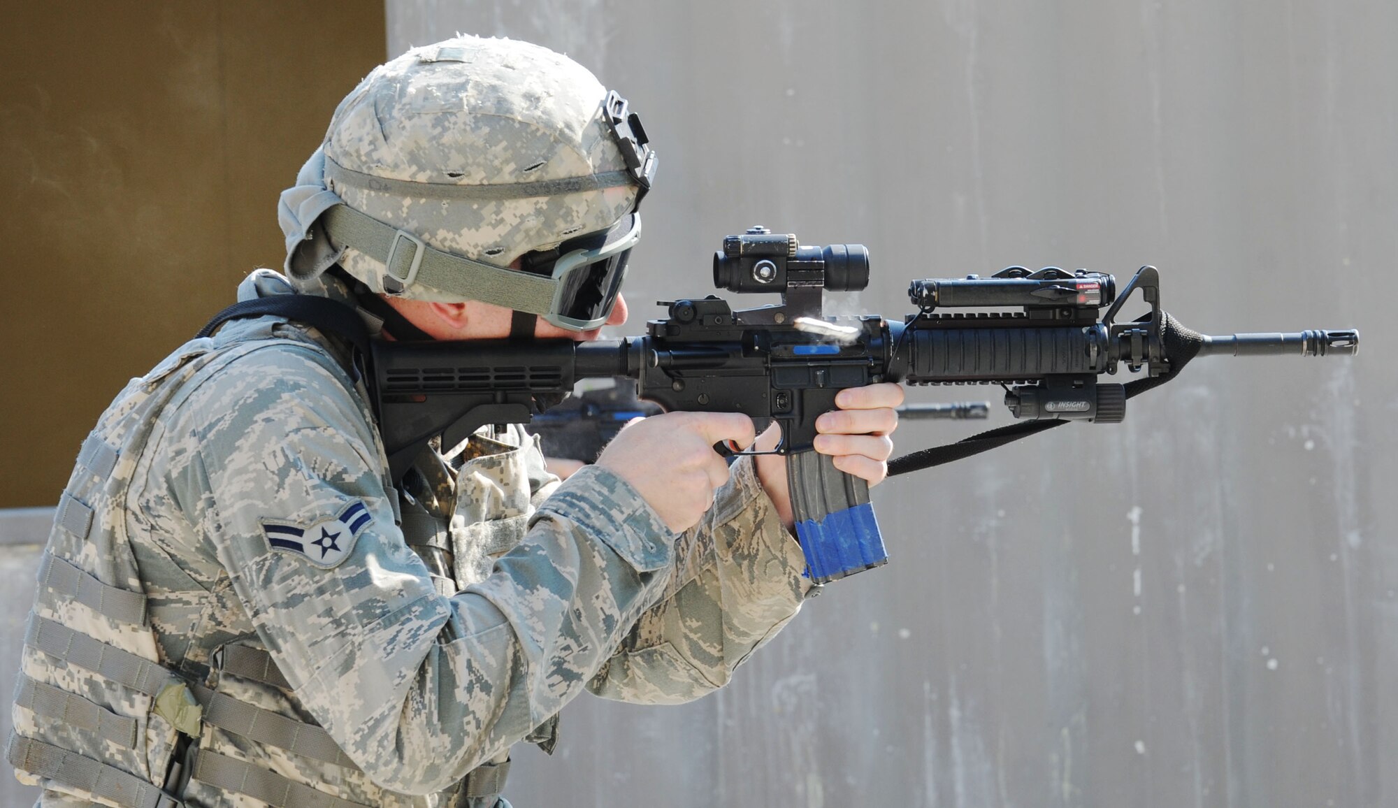 A 633rd Security Forces Squadron Airman fires rounds into a stationary target at Fort Eustis, Va., June 21, 2012. Along with basic marksmanship, participants practiced weapon transitioning techniques and communication. (U.S. Air Force photo by Airman 1st Class Austin Harvill/Released)