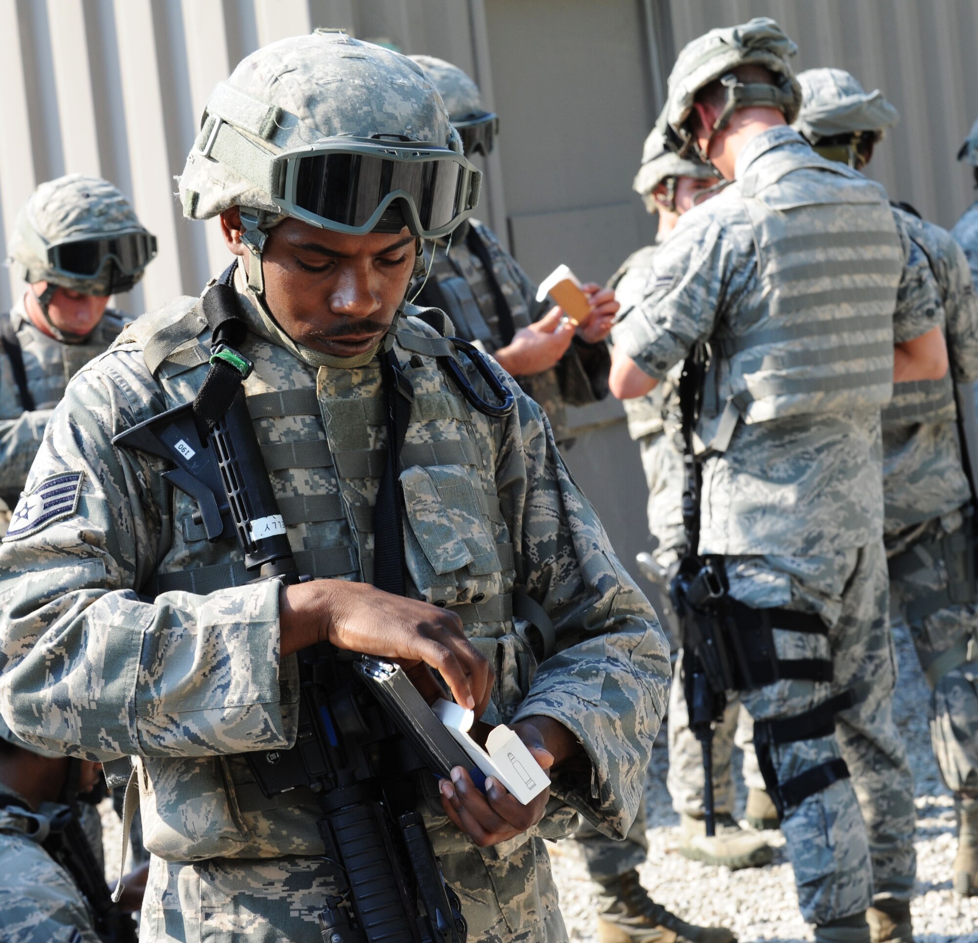 Staff Sgt. Brandon Kelly, 633rd Security Forces Squadron desk sergeant, loads his magazine with plastic, training rounds at Fort Eustis, Va., June 21, 2012. These plastic rounds are an innovative way to save money and allow familiarization with the weapon while staying safe. (U.S. Air Force photo by Airman 1st Class Austin Harvill/Released) 