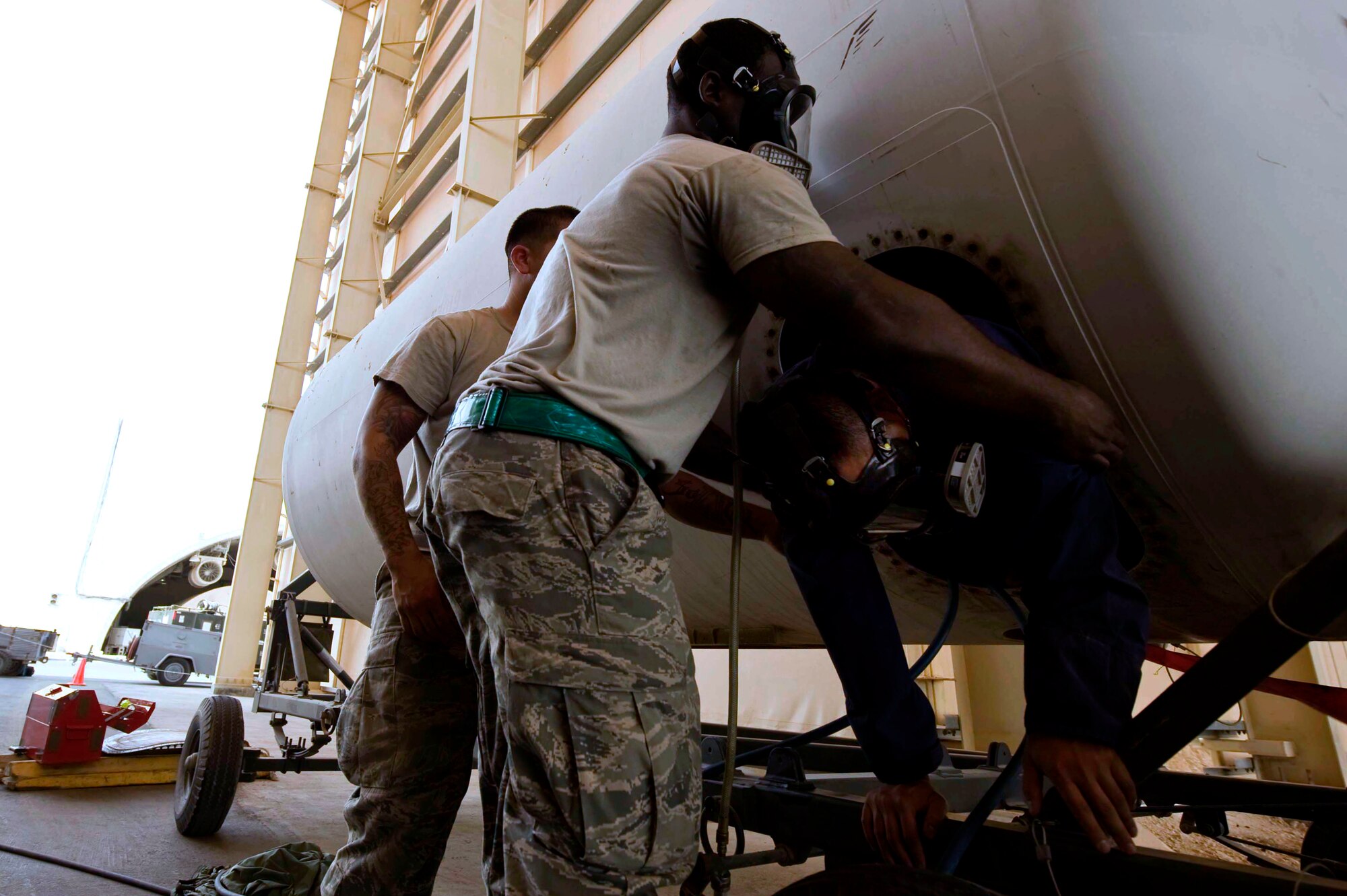 U.S. Air Force Staff Sgt. Everett West (foreground) hauls out Senior Airman Ronald Lozada during an annual confined space extraction exercise in Southwest Asia, June 19, 2012. Both Airmen are assigned to the 379th Expeditionary Maintenance Squadron. West is deployed from 7th Component Maintenance Squadron, Dyess Air Force Base, Texas and Lozada is deployed from the 22nd Maintenance Squadron, McConnell Air Force Base, Kan. (U.S. Air Force photo/Staff Sgt. Sheila deVera)