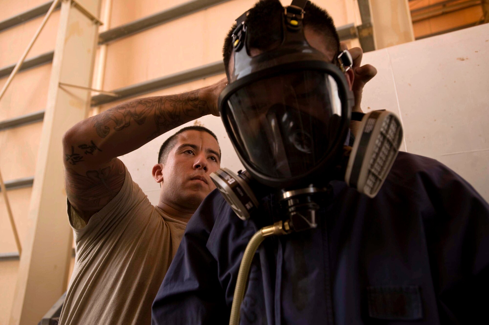 U.S. Air Force Senior Airman Robert Garcia performs a buddy check on Senior Airman Ronald Lozada donning a 3M Full Face Respirator prior to entering a B-1 Weapons bay tank during an annual confined space extraction exercise in Southwest Asia, June 19, 2012. Both Airmen are fuel system journeymen assigned to the 379th Expeditionary Maintenance Squadron. Garcia is deployed from the 452nd Maintenance Squadron, March Air Reserve Base, Calif., and is a native of Riverside, Calif., and Lozada is deployed from the 22nd Maintenance Squadron, McConnell Air Force Base, Kan., and is a native of Salinas, Calif. (U.S. Air Force photo/Staff Sgt. Sheila 
