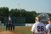 The 910th Airlift Wing color guard presents the colors during the singing of the National Anthem while a YARS C-130H Hercules aircraft performs a low-level flyover at the Mahoning Valley Scrappers’ home opener Wednesday, June 20, 2012. To celebrate the home opener and in honor of the Scrappers’ military appreciation night, Col. Reinhard Schmidt, commander of the 910th Airlift Wing, threw out the first pitch. Air Force recruiters from YARS set up a display table on the concourse and made their presence known by parading Airman Andy, a large inflatable mascot, through the stands to greet fans. As fans entered the stadium, they were able to view a Humvee from the Marine Corps Reserve Landing Support Equipment Company, Youngstown.