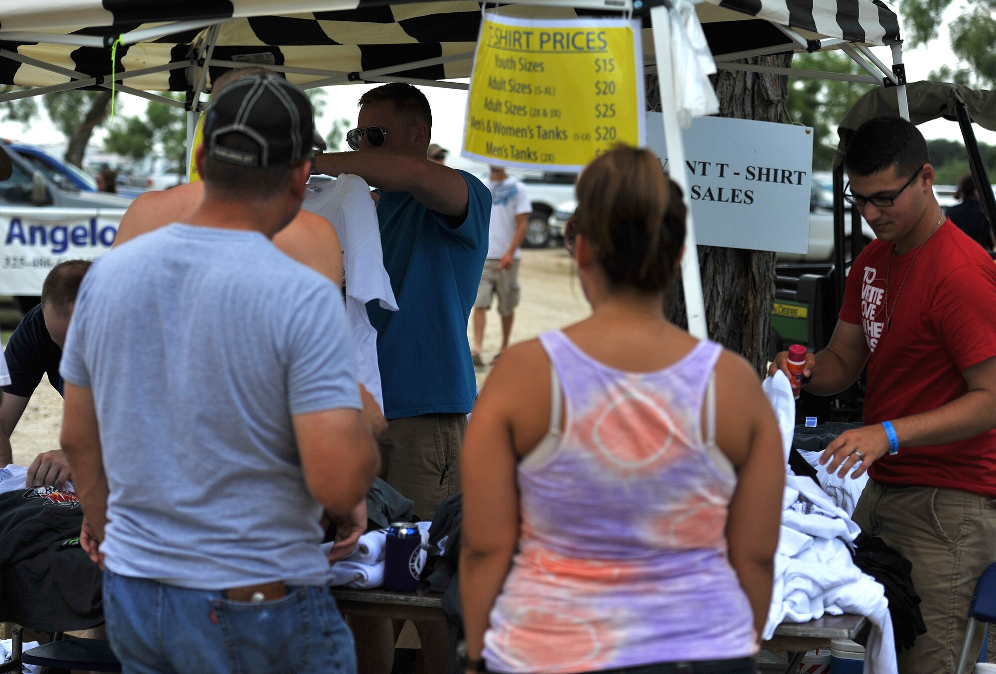 SAN ANGELO, Texas-- Volunteers from Team Goodfellow help with the sale of souvenirs during the Sixth Annual San Angelo Showdown drag boat races at Lake Nasworthy, June 23.  More than 200 volunteers came out to help with security, guiding traffic, and recycling. (U.S. Air Force photo/Airman 1st Class Michael Smith)