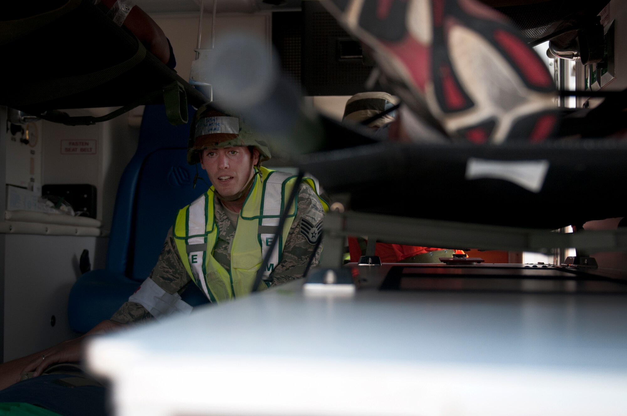 A member of the 31st Medical Group waits for another casualty to be loaded into an ambulance during a major accident response exercise at Aviano Air Base June 20. Inspector general team members simulated a base attack to gauge first responders’ ability to react to an attack. (U.S. Air Force photo/Senior Airman Katherine Windish)
