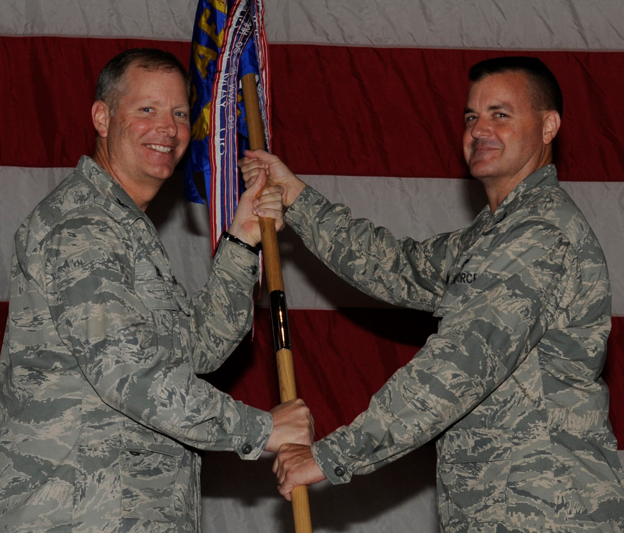 SOUTHWEST ASIA - Col. Michael Zick, 386th Air Expeditionary Wing commander, gives the 386th Expeditionary Mission Support Group guidon to Col. Joseph Martin, during the change of command ceremony here June 26, 2012. (U.S. Air Force photo/Staff Sgt. Alexandra M. Boutte)