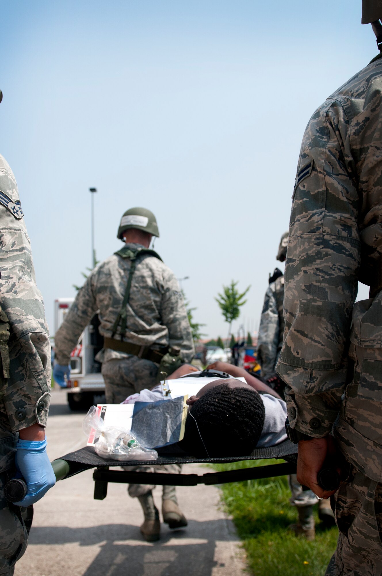 Members of the 31st Medical Group carry a simulated casualty to an ambulance during a major accident response exercise at Aviano Air Base June 20. During the MARE, inspectors were on-scene to assess first responders’ ability to react to crisis situations. (U.S. Air Force photo/Senior Airman Katherine Windish)