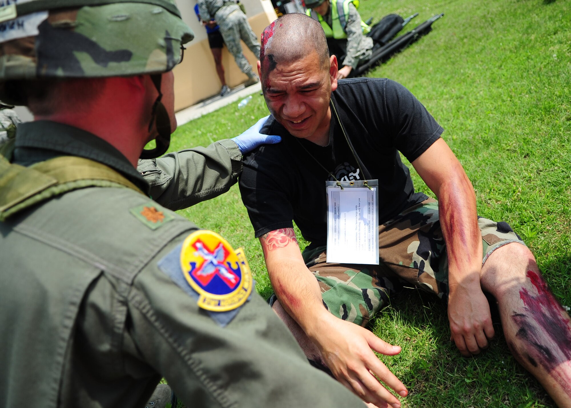 A flight surgeon checks the status of a simulated explosion casualty during a major accident response exercise at Aviano Air Base June 20. To add realism to the scenario, “victims” were painted with moulage and acted as if they were in pain. (U.S. Air Force photo/Staff Sgt. Evelyn Chavez)