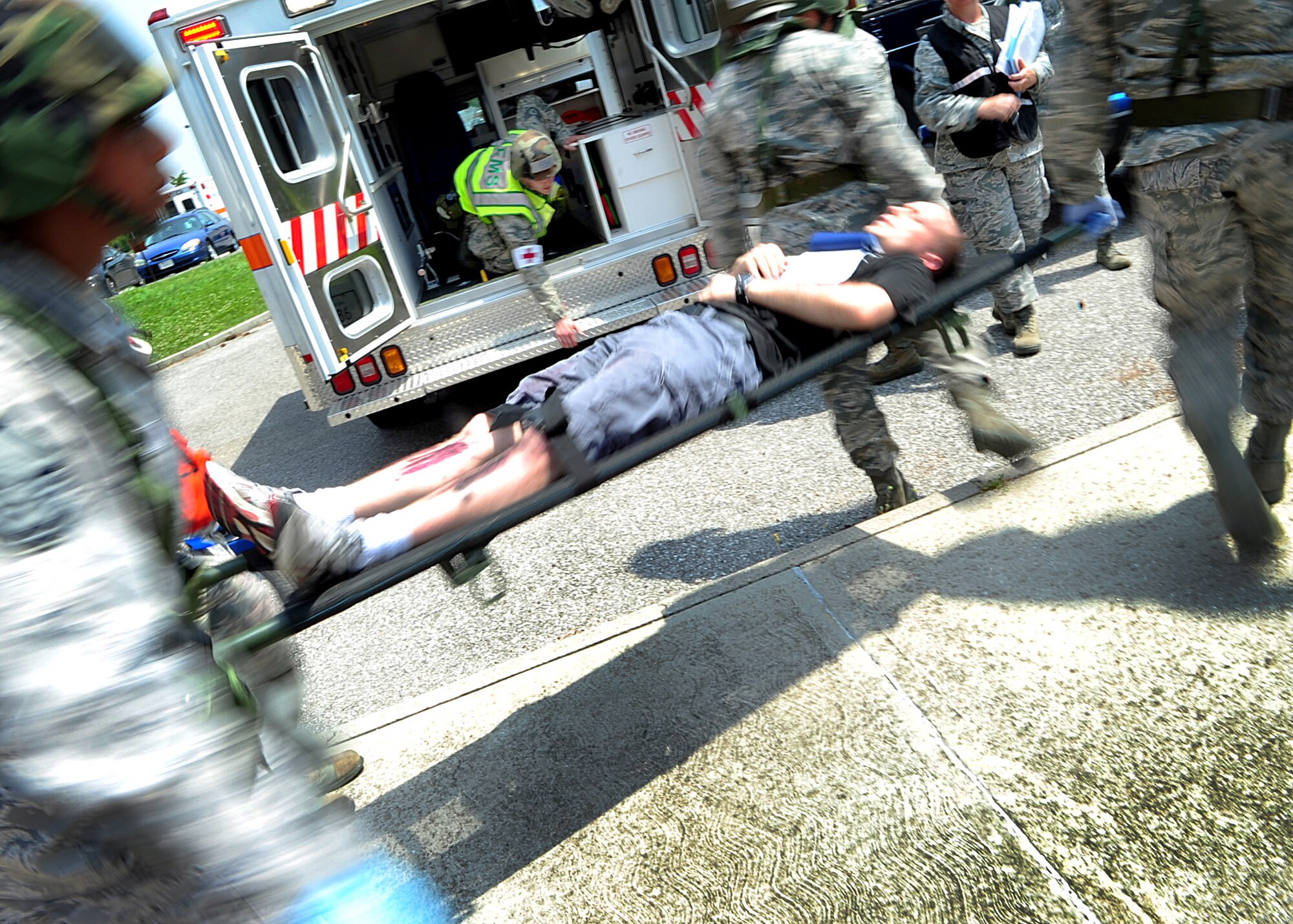 Medics load a simulated casualty into an ambulance for treatment after a simulated explosion during a major accident response exercise at Aviano Air Base June 20. Members of the 31st Medical Group were key players during the MARE and were graded on how well they were able to respond to the attack and treat patients. (U.S. Air Force photo/Staff Sgt. Evelyn Chavez)