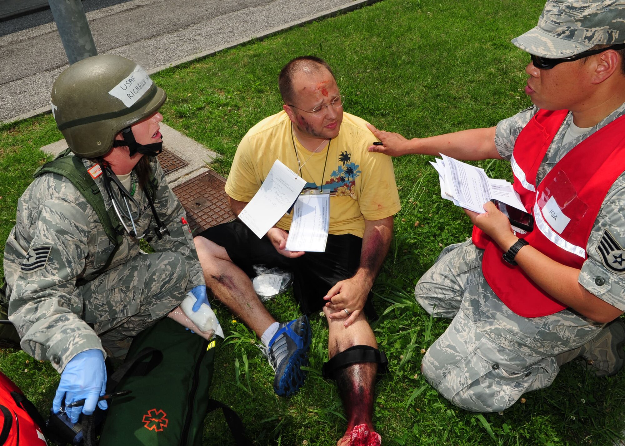 An inspector general augmentee questions a medic during a major accident response exercise at Aviano Air Base June 20. The IG team used the exercise to gauge the preparedness of Aviano first responders and their ability to work together to accomplish the mission during a crisis situation. (U.S. Air Force photo/Staff Sgt. Evelyn Chavez)