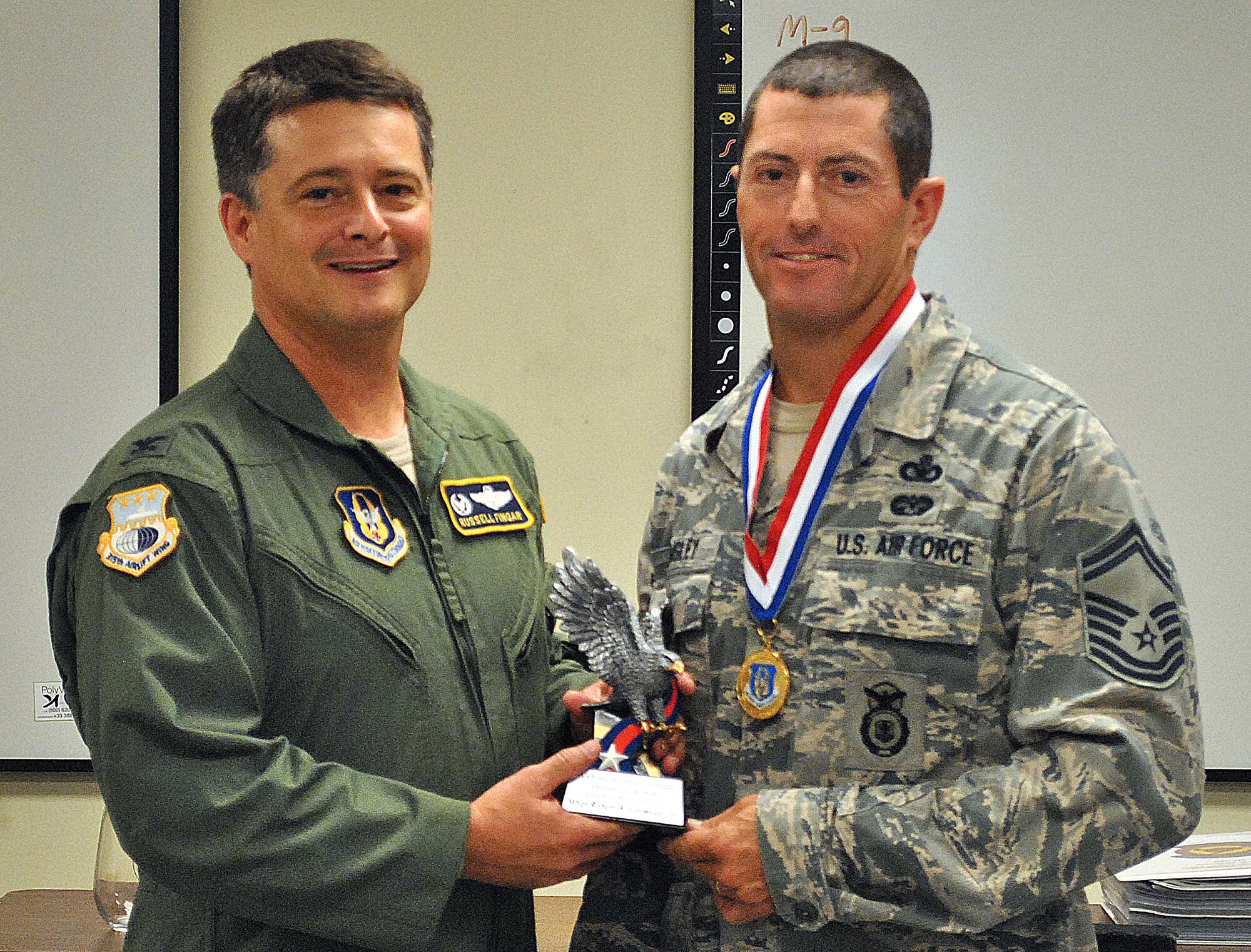 Master Sgt. Rob Grimsely, 315th Security Forces Squadron, was presented with a medal and trophy for being named 4th Air Force's Outstanding Airman of the Year 
Colonel Russell Fingar, Commander 315th Airlift Wing, presided over the ceremony held during the Unit Training Assembly. Sergeant Grimsely was selected as the Senior Noncommissioned Officer of the Year for the 315th Airlfit Wing earlier this year.