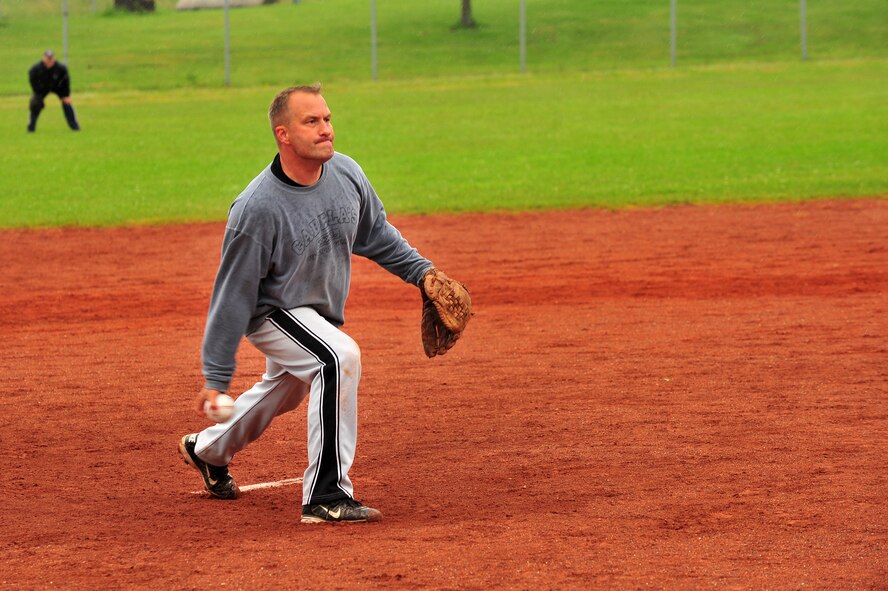 SPANGDAHLEM AIR BASE, Germany – Jason Bouchard, Geilenkirchen B Team pitcher, pitches a softball during the first Top IV sponsored Ammo Softball Tournament championship game against the LMS Team on Field 2 here June 24. The GK B Team beat the LMS team 19-12. The tournament consisted of 9 teams and spanned three days. (U.S. Air Force photo by Airman 1st Class Dillon Davis/Released)