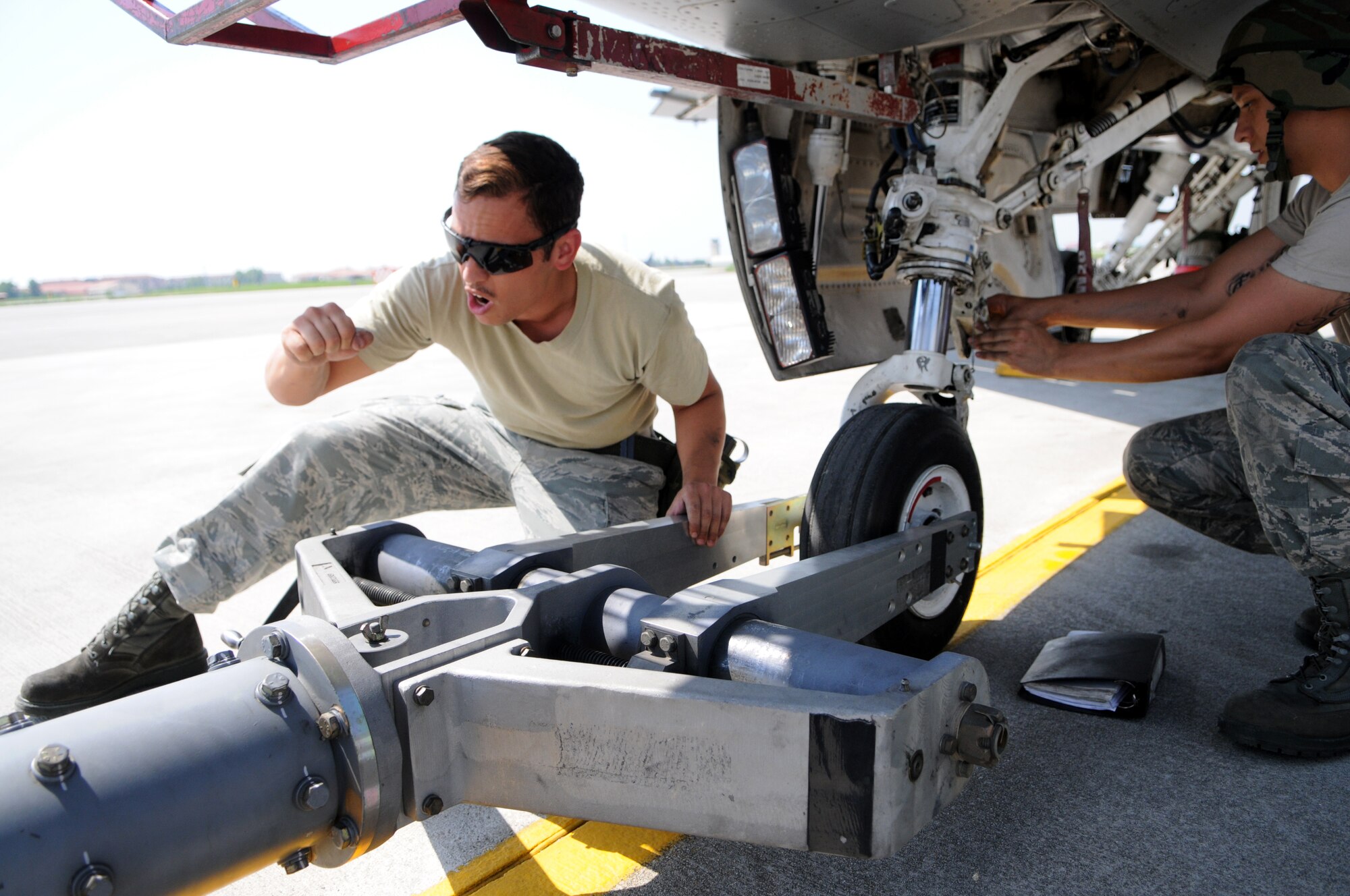 Senior Airman Steven Losada, 31st Maintenance Squadron crew chief, prepares to tow an F-16 Fighting Falcon June 21 at Aviano Air Base. During a phase inspection, Airmen from several different career fields work together to ensure the jets stay mission-ready. (U.S. Air Force photo/Senior Airman Katherine Windish)