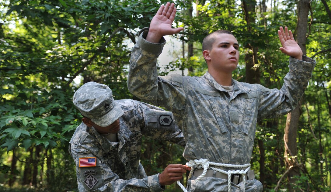 U.S. Army Staff Sgt. Danneit Disla, 98th Reserve Division, Drill Sergeant of the Year competitor, checks for discrepancies on a Swiss-Seat repel harness worn by Pvt. Michael Melton, June 22, 2012, at Fort Eustis, Va. Disla is one of six competitors for the 2012 Drill Instructor of the Year Competition. (U.S. Air Force photo by Senior Airman Stephanie Rubi/Released)
