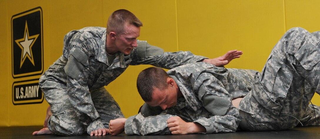 U.S. Army Sergeant 1st Class Adam McQuiston, Fort Leonard Wood, Mo., drill instructor, directs two Soldiers on the proper way to perform a combative move, June 25, 2012, during the annual Drill Sergeant of the Year competition at Fort Eustis, Va. McQuiston is one of six drill sergeants competing in this weeklong competition for the title. (U.S. Air Force photo by Senior Airman Wesley Farnsworth/Released)