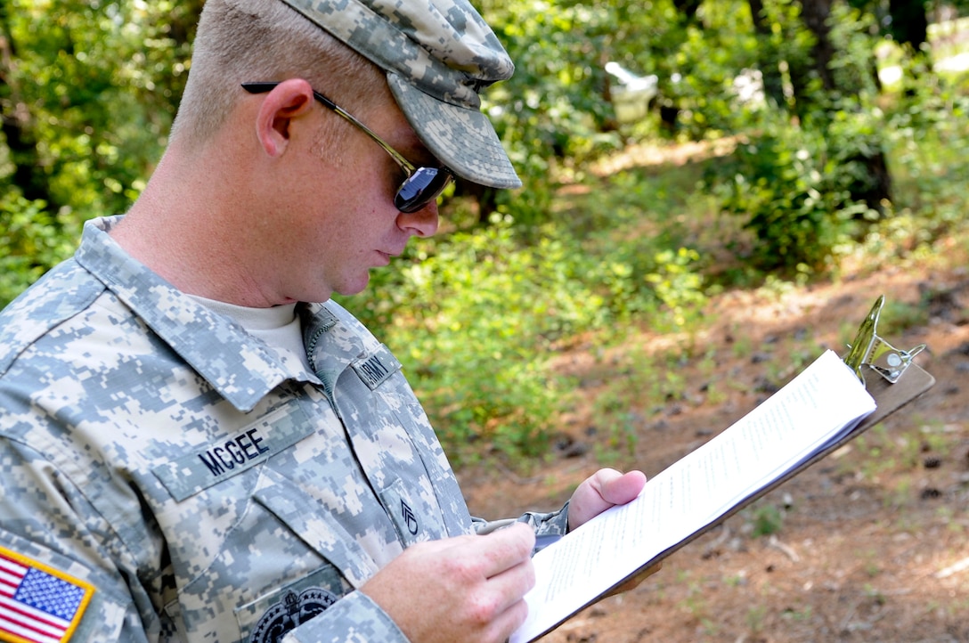 U.S. Army Staff Sgt. Jody McGee, Drill Sergeant of the Year grader, reviews a score sheet during a DYOY event, June 25, 2012, at Fort Eustis, Va. The annual competition puts drill sergeants through various physical and mental challenges to compete for the Drill Sergeant of the Year title. (U.S. Air Force photo by Senior Airman Wesley Farnsworth/Released)