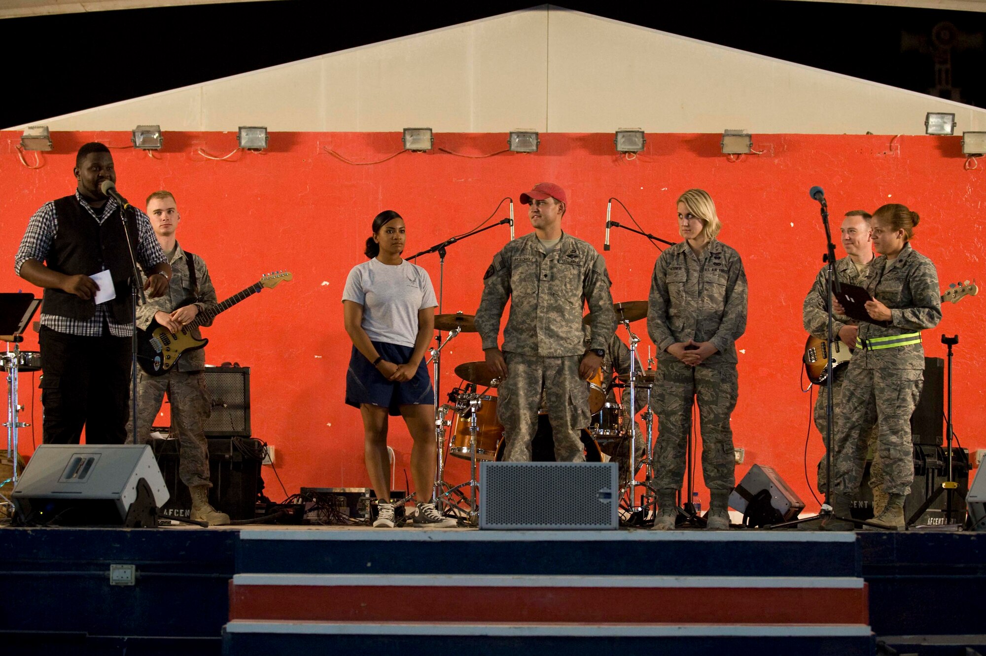 The final three contestants wait patiently for the winner of 'The Voice' finals after advancing each round. (U.S. Air Force photo/Staff Sgt. Sheila deVera)