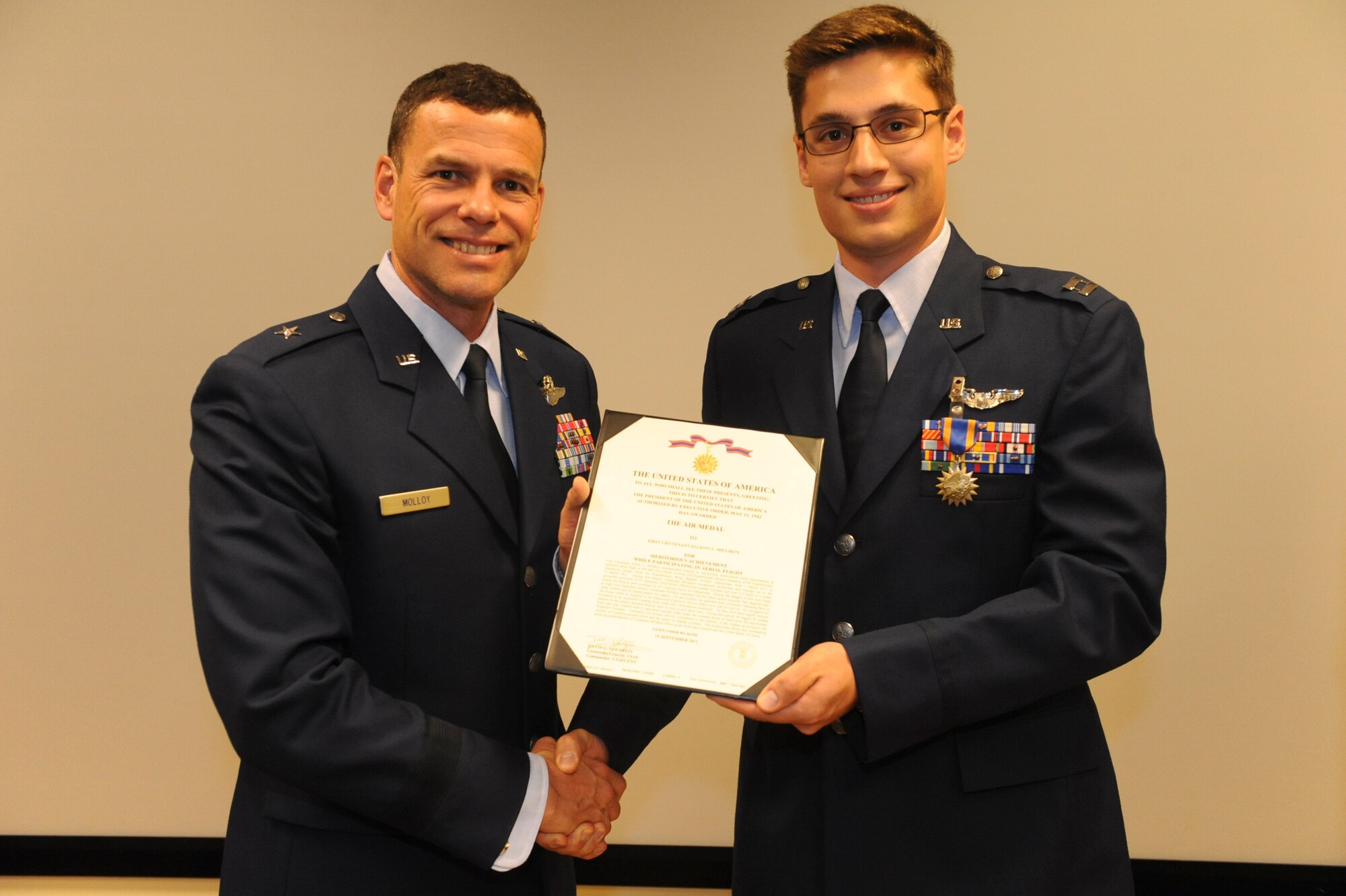 U.S. Air Force Capt. Elliot Milliken, 33rd Rescue Squadron, receives the Air Medal from Brig. Gen. Matthew Molloy, 18th Wing commander, at the 33rd RQS auditorium on Kadena Air Base, Japan, June 20, 2012. Milliken was among seven 33rd RQS Airmen presented medals for various achievements including deployment actions in Afghanistan.  (U.S. Air Force photo/Airman 1st Class Justin Veazie)