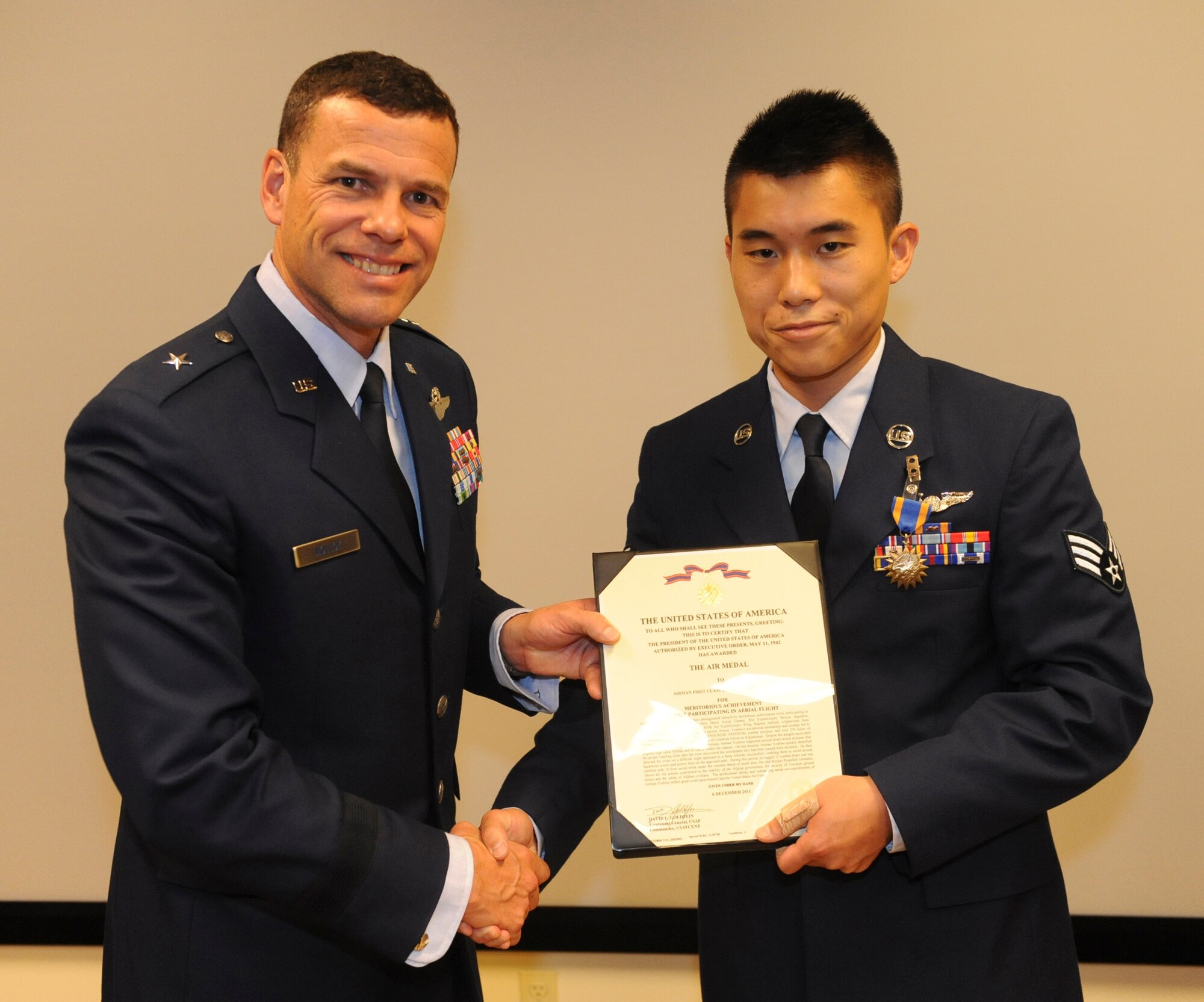 U.S. Air Force Senior Airman Takashi Yoshino, 33rd Rescue Squadron, receives the Air Medal from Brig. Gen. Matthew Molloy, 18th Wing commander, at the 33rd RQS auditorium on Kadena Air Base, Japan, June 20, 2012. Yoshino was among seven 33rd RQS Airmen presented medals for various achievements including deployment actions in Afghanistan.  (U.S. Air Force photo/Airman 1st Class Justin Veazie)