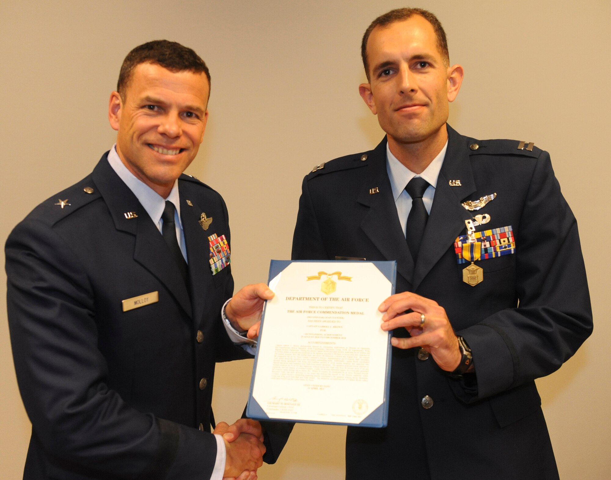 U.S. Air Force Capt. Gabriel Brown, 33rd Rescue Squadron, receives the Air Force Commendation Medal from Brig. Gen. Matthew Molloy, 18th Wing commander, at the 33rd RQS auditorium on Kadena Air Base, Japan, June 20, 2012. Brown was among seven 33rd RQS Airmen presented medals for various achievements including deployment actions in Afghanistan.. (U.S. Air Force photo/Airman 1st Class Justin Veazie)