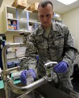 U.S. Air Force Tech. Sgt. John Horgan, 18th Aerospace Medicine Squadron, Bioenvironmental Engineering Flight, demonstrates the steps in taking a water sample on Kadena Air Base, June 25, 2012. Horgan and his fellow Airmen from the Bioenvironmental Engineering Flight have taken water samples throughout the year to build an annual Consumer Confidence Report that lets the public know the quality of water on the air base, as well as the military family housing units around Okinawa. (U.S. Air Force photo/Staff Sgt. Laszlo Babocsi)