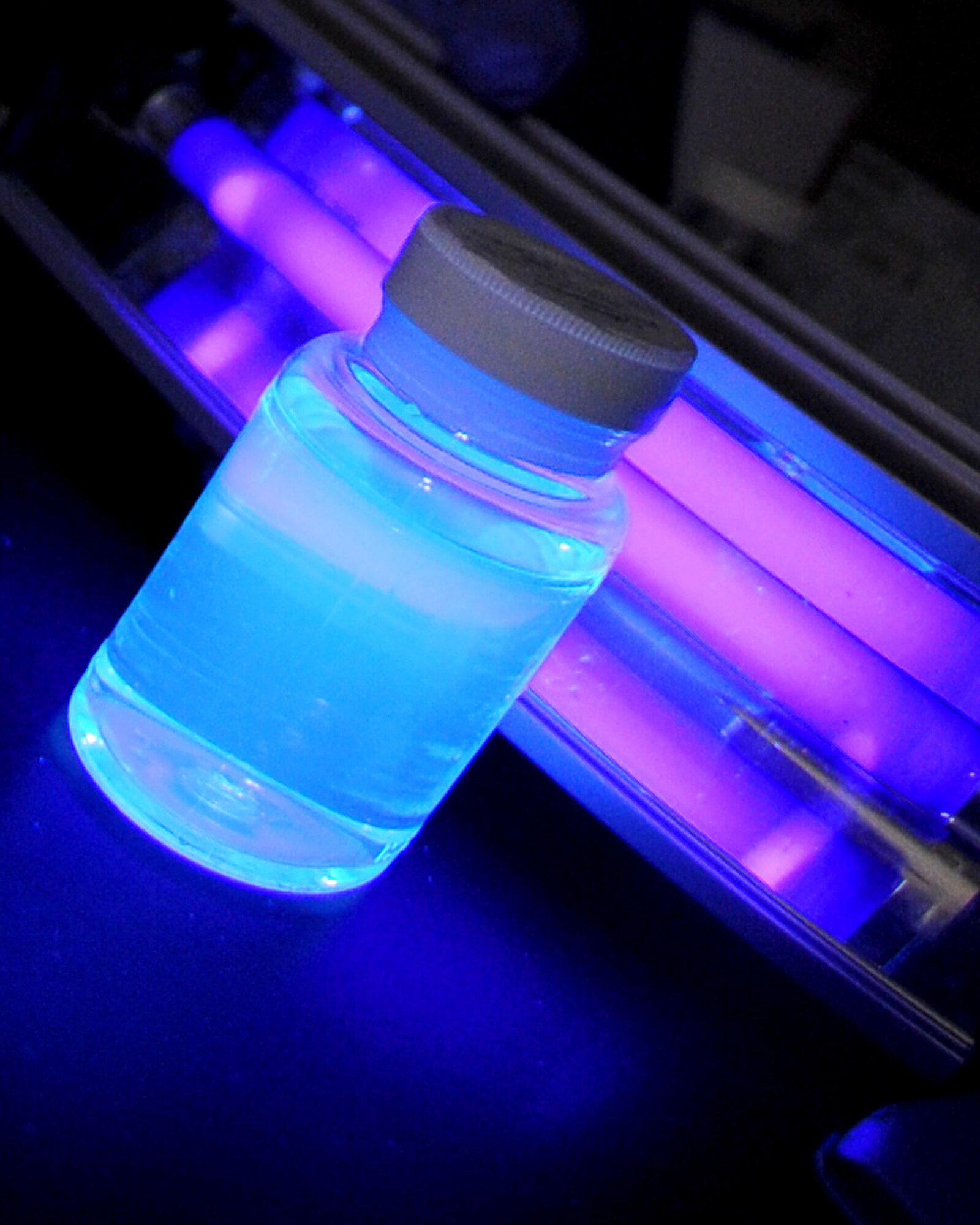 U.S. Air Force Tech. Sgt. John Horgan, 18th Aerospace Medicine Squadron, Bioenvironmental Engineering Flight, demonstrates what a contaminated water sample looks like under a black light after its incubation period (24 hours) on Kadena Air Base, June 25, 2012. Horgan and his fellow Airmen from the Bioenvironmental Engineering Flight have taken water samples throughout the year to build an annual Consumer Confidence Report that lets the public know the quality of water on the air base, as well as the military family housing units around Okinawa. (U.S. Air Force photo/Staff Sgt. Laszlo Babocsi)