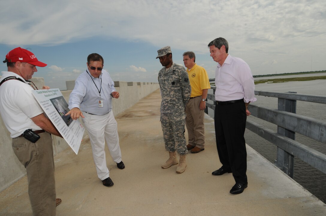 LOUISIANA — Lt. Gen. Thomas Bostick, Commanding General of the U.S. Army Corps of Engineers, signed the "Louisiana Coastal Area Barataria Basin Barrier Shoreline Restoration" report June 22, 2012 on top of the Inner Harbor Navigation Canal Surge Barrier. Col. Edward Fleming, U.S. Army Corps of Engineers New Orleans District commander, highlighted the united front federal, state and local agencies are taking in support of the Hurricane and Storm Damage Risk Reduction System building built here. The HSDRRS system is referred to as the best the area has ever had regarding storm risk reduction. On hand for the ceremony was U.S. Sen. David Vitter.
