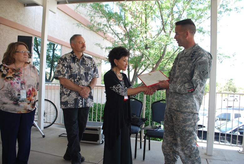 Sue "Hwa Soon" Thorson recieves a certificate of appreciation for delivering the keynote speech on May 24.