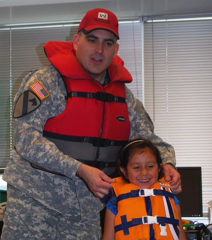 Lt. Col. Richard Collins and a student demonstrate life jacket safety.