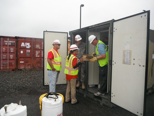 Quality Assurance Representative, Joe Tribbey (left), Logistics Specialist, Marsha Phillips (middle), and 249th Engineer Battalion "Yard Dog", SFC Douglas Eshenbaugh, inventorying reviewing generator work order requests with generator support contractor during Day 1 of the Evergreen Earthquake Exercise generator staging area located on Joint Base Lewis-McChord.