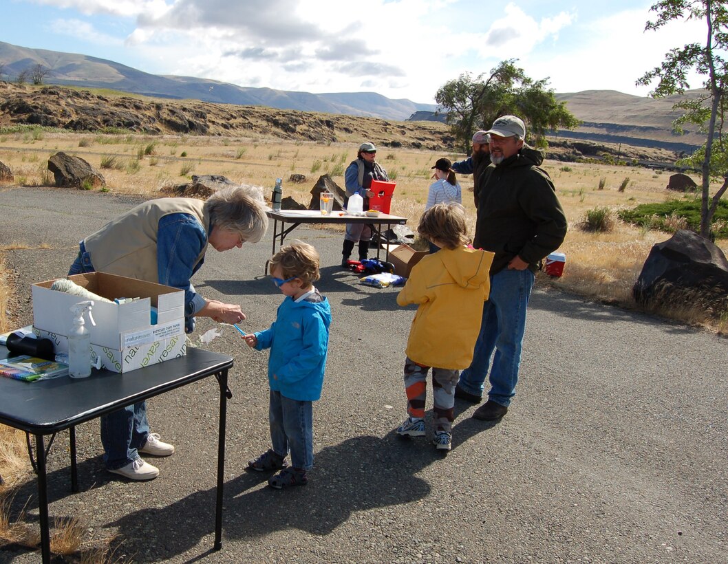 Family Fishing Day was at at Spearfish Park on Saturday, June 9, 2012, in conjunction with Washington`s free fishing weekend, so no fishing licenses were required.

The Washington Dept. of Fish and Wildlife stocked the lake with over 2,000 trout the day before the event, and provided staff support and more than 100 fishing poles for the event. The kids even got to keep their poles!

Trout Unlimited, of Goldendale, Wash., had a demonstration booth and taught participants how to bait their tackle. Local volunteers Tom and Velda Pierce staffed the activity booths. Tom taught casting skills so that kids could practice aiming while casting. Velda helped kids color and assemble fish and water safety craft. Volunteers also helped Ranger David Ladouceur at the water safety booth.

A Dalles Dam Fisheries employee, Erin Kolvachuk, brought a display and taught visitors how to identify different species of fish and answered questions about pit tagging.

Prizes were raffled off, and attendance was great despite windy conditions, with about 100 participants enjoying a Saturday morning outdoors, learning how to fish, and actually catching some, too!