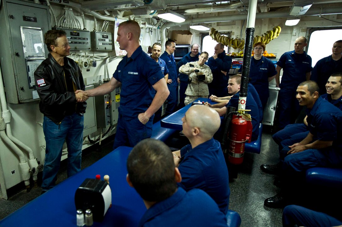 Gary Sinise, left, actor and bass guitarist for the Lt. Dan Band, meets with Coast Guardsmen aboard the Coast Guard Cutter Munro on Coast Guard Air Station Kodiak, Alaska, June 25, 2012. 