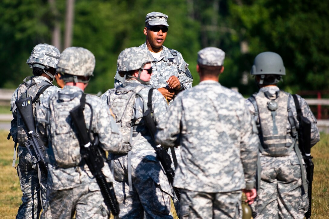 Army Sgt. Mark Banks gives his troops a pre-mission brief during the react-to-contact course on Camp Atterbury, Ind., June 21, 2012. Banks, a chemical team leader, is assigned to the 438th Chemical Company, 81st Troop Command, Indiana National Guard.