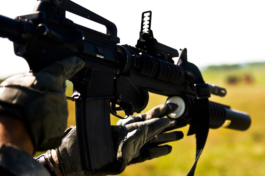 A soldier prepares to load an M203 grenade launcher before firing a round at targets down range on Camp Atterbury, Ind., June 21, 2012. The soldier is assigned to the Indiana National Guard. 