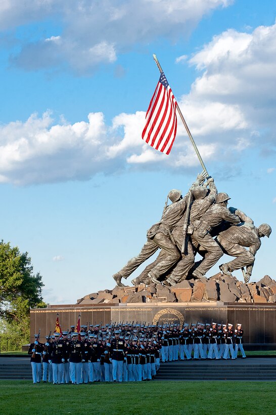 Marchers from Marine Barracks Washington march onto the parade deck during a Sunset Parade at the Marine Corps War Memorial June 26.
