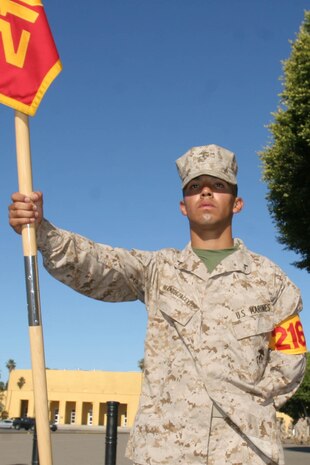 Lance Cpl. Joseph Bermudez, Platoon 2169, Company H, 2nd Recruit Training Battalion, stands with the guidon June 26 aboard Marine Corps Recruit Depot San Diego. Bermudez's maturity, willingness and leadership earned him the billet of guide throughout recruit training. He plans on being a successful example for his 22-month-old daughter, Juliet Rose, one day.