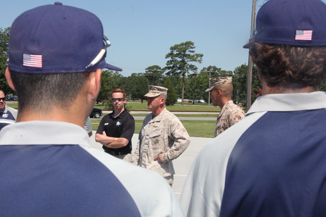 Col. Philip J. Zimmerman, the commanding officer of Cherry Point, welcomes the men of Team USA's baseball team as the arrive at the station theater for the Corporals Leadership Course graduation ceremony, June 27.