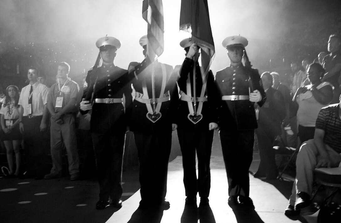 The 9th Marine Corps District color guard carries the colors before a crowd of thousands of high school and college students during the SkillsUSA awards ceremony, June 27.::r::::n::