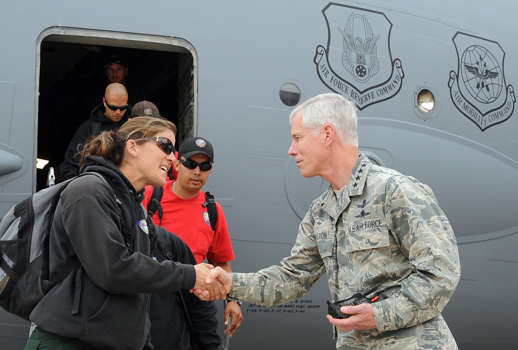 General William Shelton, Commander of Air Force Space Command, greets members of the Vandenberg Hot Shots fire fighting team as they arrive at Peterson Air Force Base, Colo., June 27.  The Hot Shot firefighting crew is specially trained and equipped to prevent and suppress wildfires. They are the only specialized DoD wildland fire fighting team of their kind and are in Colorado Springs supporting Waldo Canyon Fire suppression efforts. (U.S. Air Force Photo/Duncan Wood)