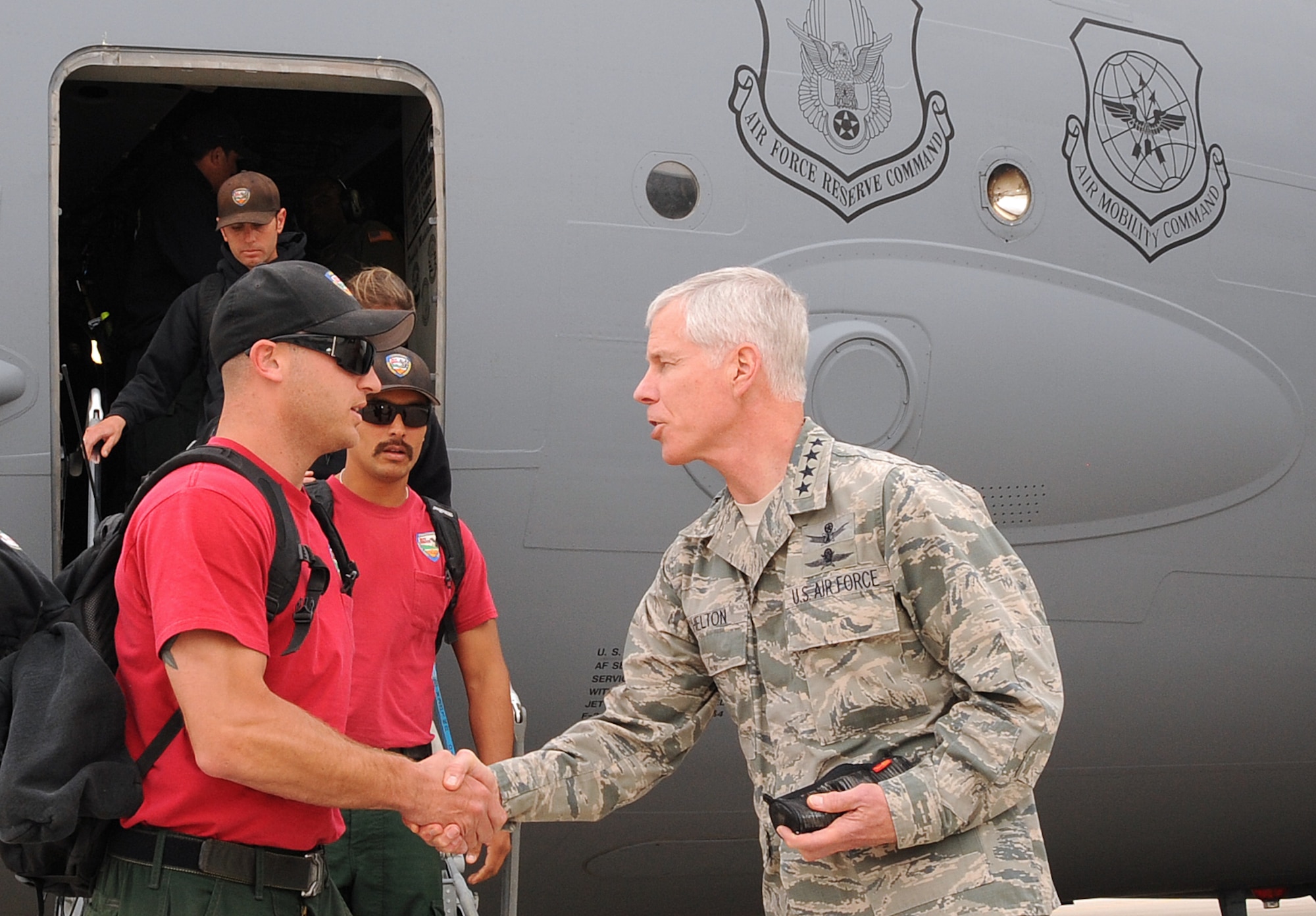 General William Shelton, Commander of Air Force Space Command, greets members of the Vandenberg Hot Shots fire fighting team as they arrive at Peterson Air Force Base, Colo., June 27.  The Hot Shots are the only specialized DoD wildland fire fighting team of their kind and are in Colorado Springs supporting Waldo Canyon Fire suppression efforts. (U.S. Air Force Photo/Duncan Wood)