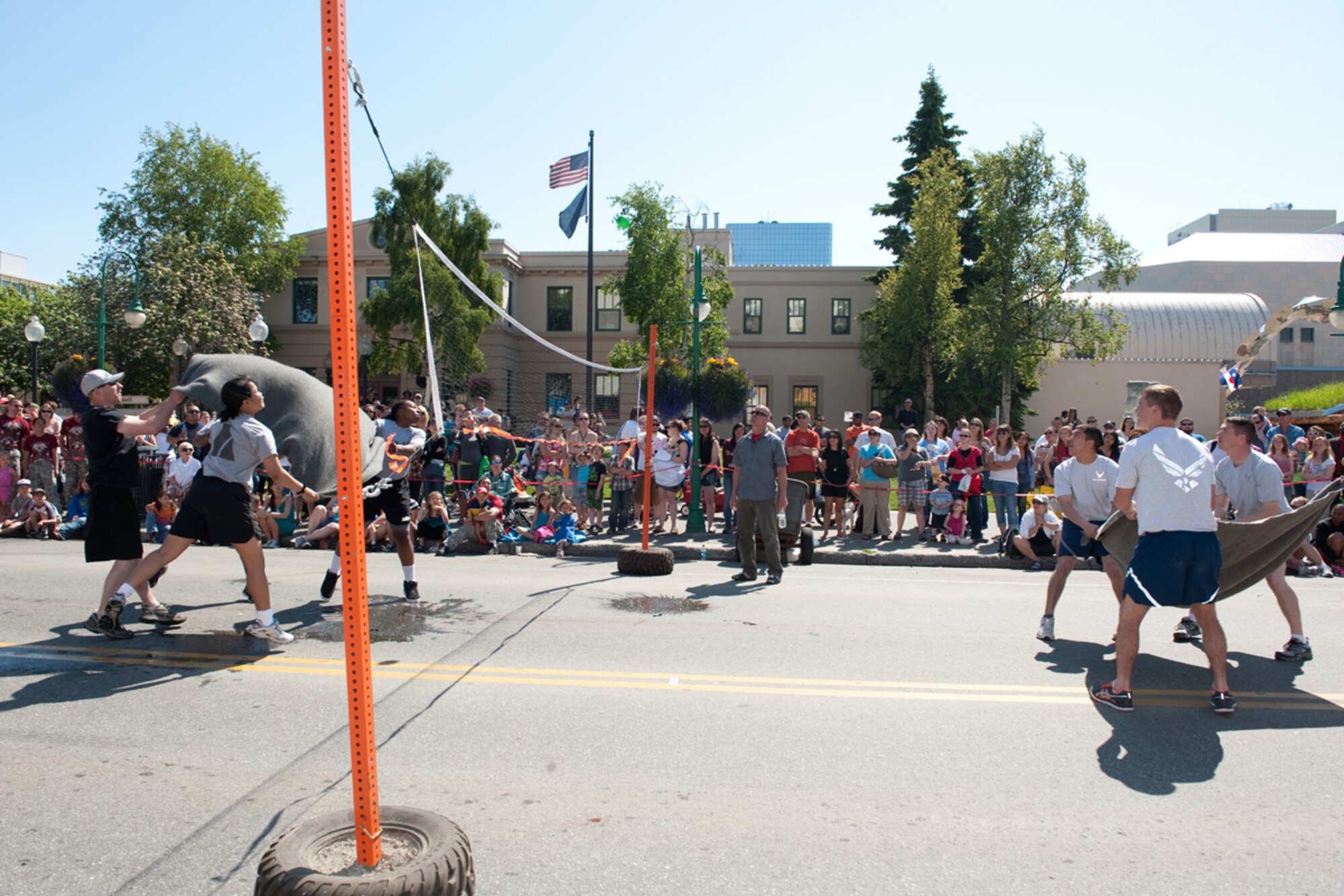 An Army team blanket-tosses a water balloon into the Air Force team’s side of the court during the water-balloon volleyball event at the Hero Games in Anchorage. 