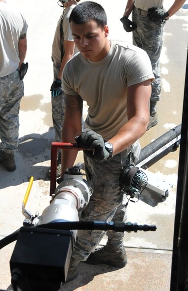 Airman 1st Class Dom Gastelum, hydraulics systems technician, 52nd Airlift Squadron, loads Phos-Chek fire retardant into a MAFFS-equipped C-130 Hercules. The MAFFS unit can hold up to 3,000 gallons of retardant for aerial fire-fighting efforts. (U.S. Air Force photo/Airman 1st Class Nichole Grady)